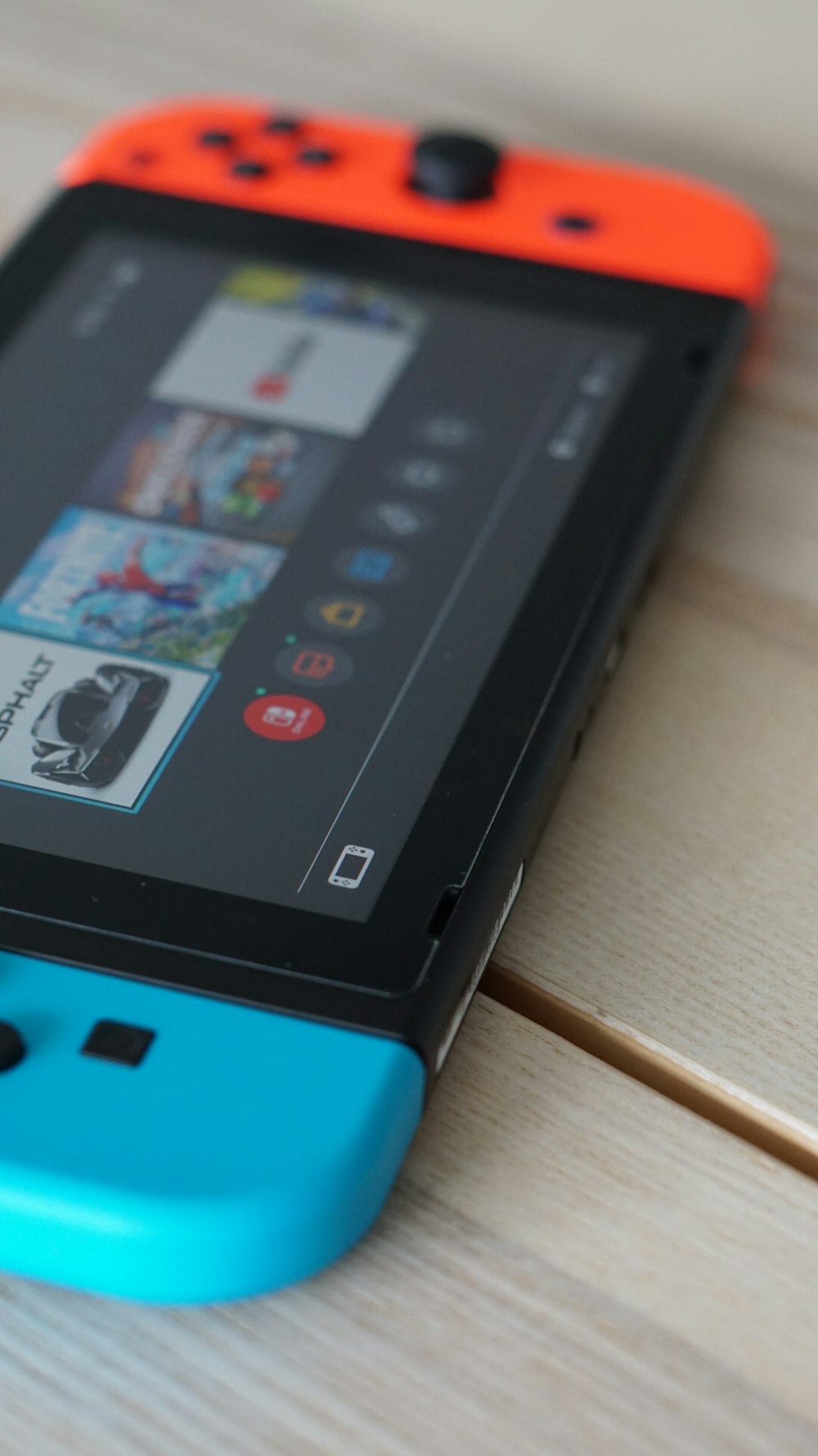 a blue and orange phone sitting on top of a wooden table