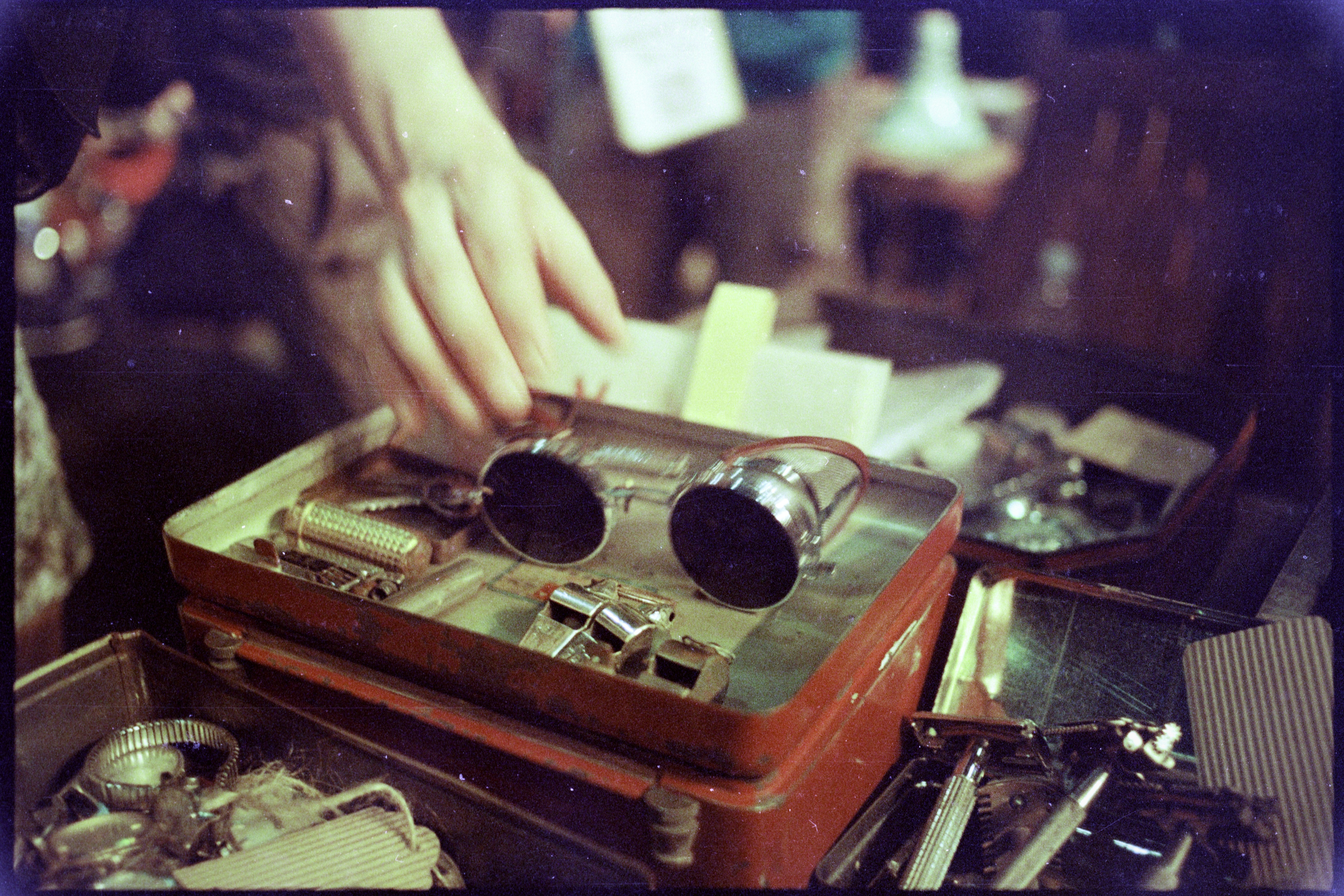 a person touching a pair of sunglasses on top of a table