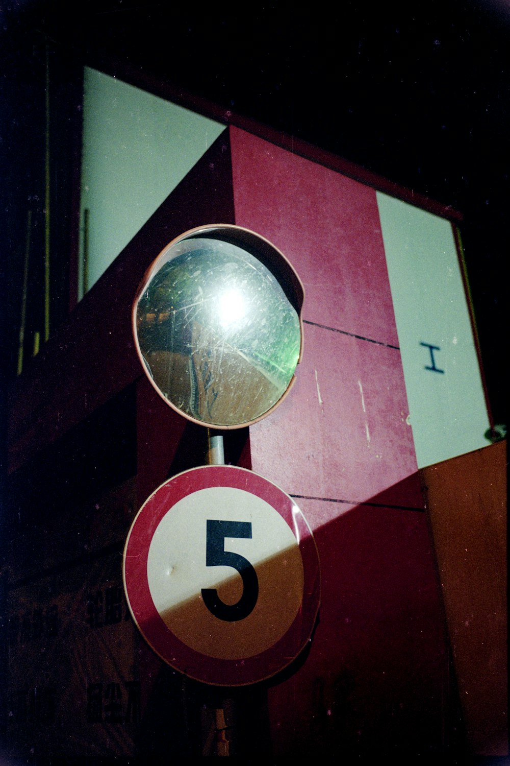 a street sign with a mirror on top of it