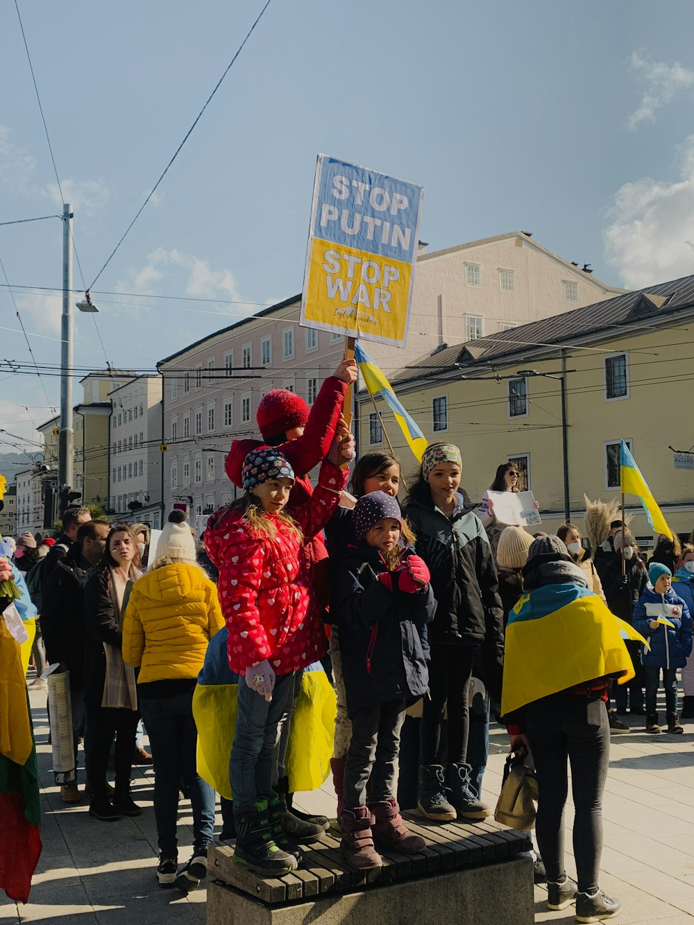 a group of people standing around each other holding signs