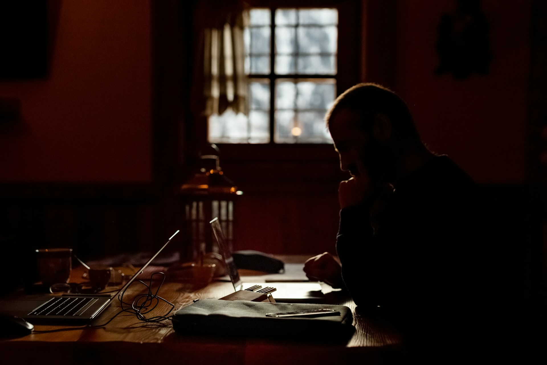a person sitting at a table in a dark room