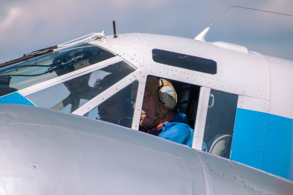a man sitting in the cockpit of a small airplane