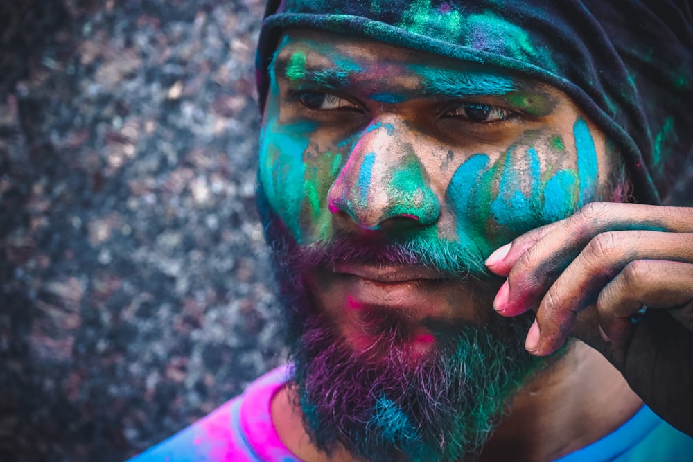 a man with colorful paint on his face