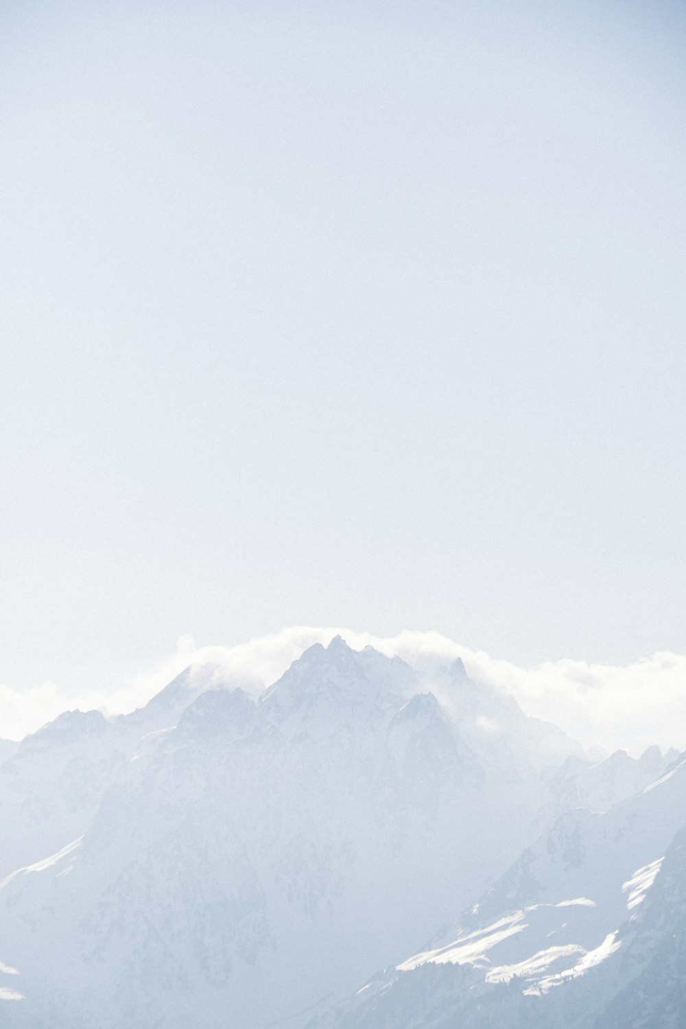 a man riding skis on top of a snow covered slope