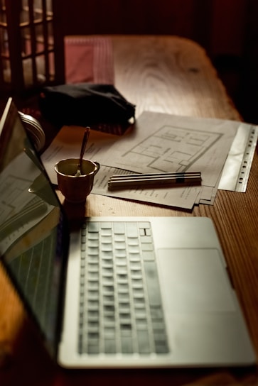 a laptop computer sitting on top of a wooden table
