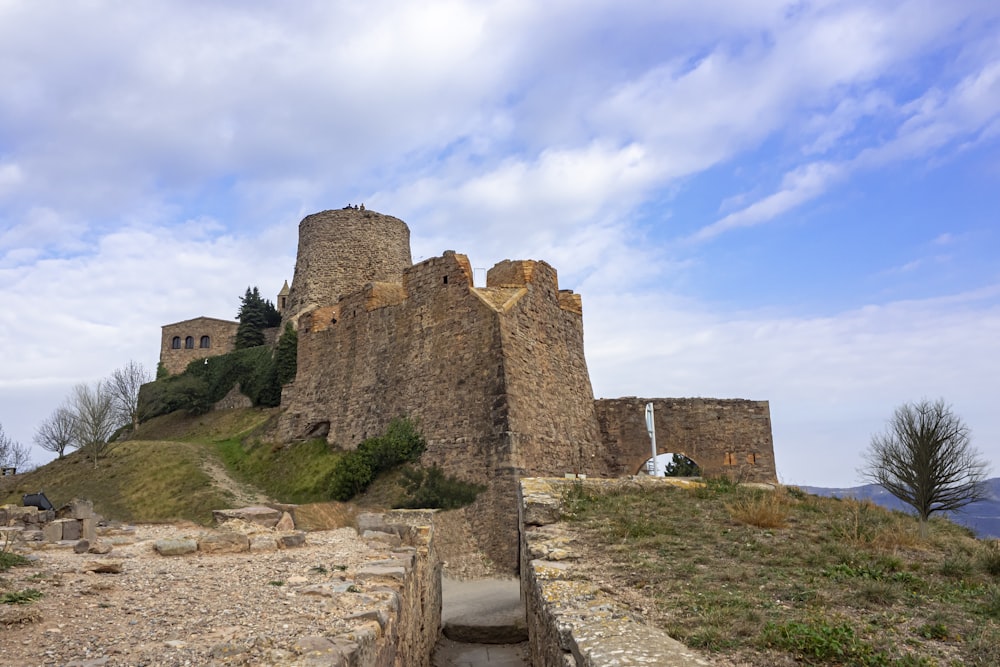 a stone castle sitting on top of a hill