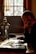 An image of a person thoughtfully using a laptop in a cozy workspace.