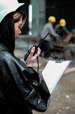 a woman in a raincoat holding an umbrella