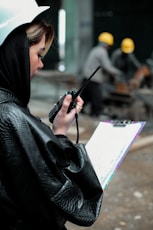 a woman in a raincoat holding an umbrella