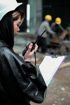 a woman in a raincoat holding an umbrella