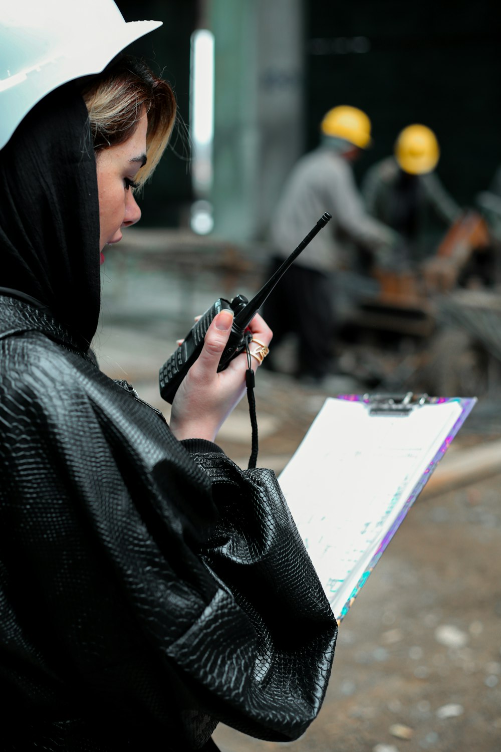 a woman in a raincoat holding an umbrella