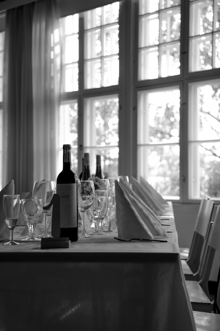 a table with wine bottles and glasses on it