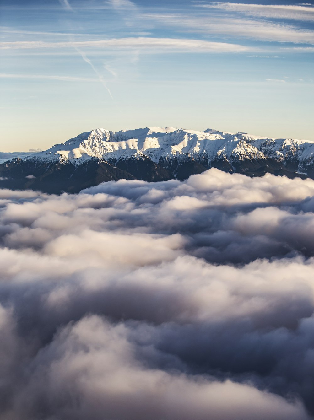 a view of a mountain covered in clouds