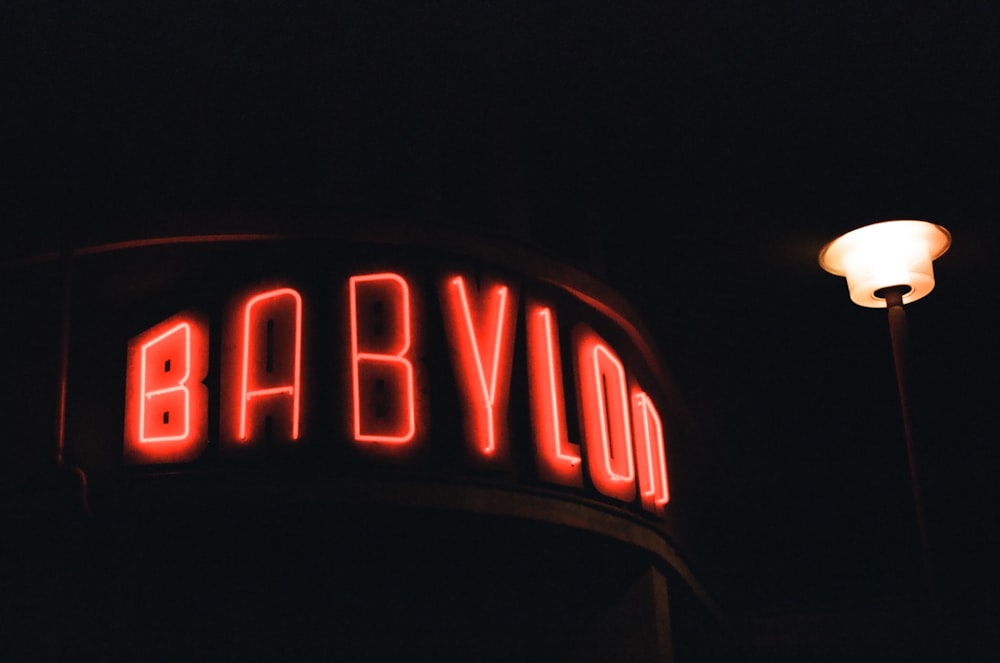 a red neon sign that says babvolo on it