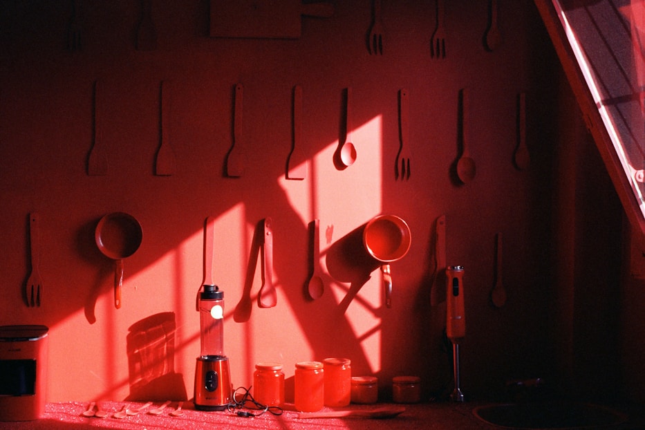 a red room with utensils hanging on the wall