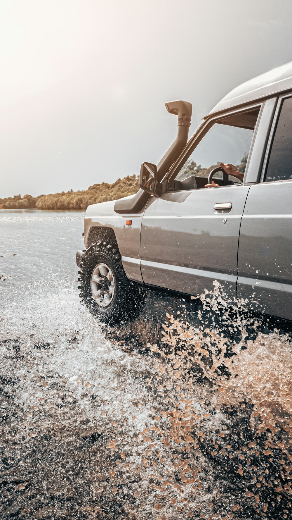 a truck driving through a body of water