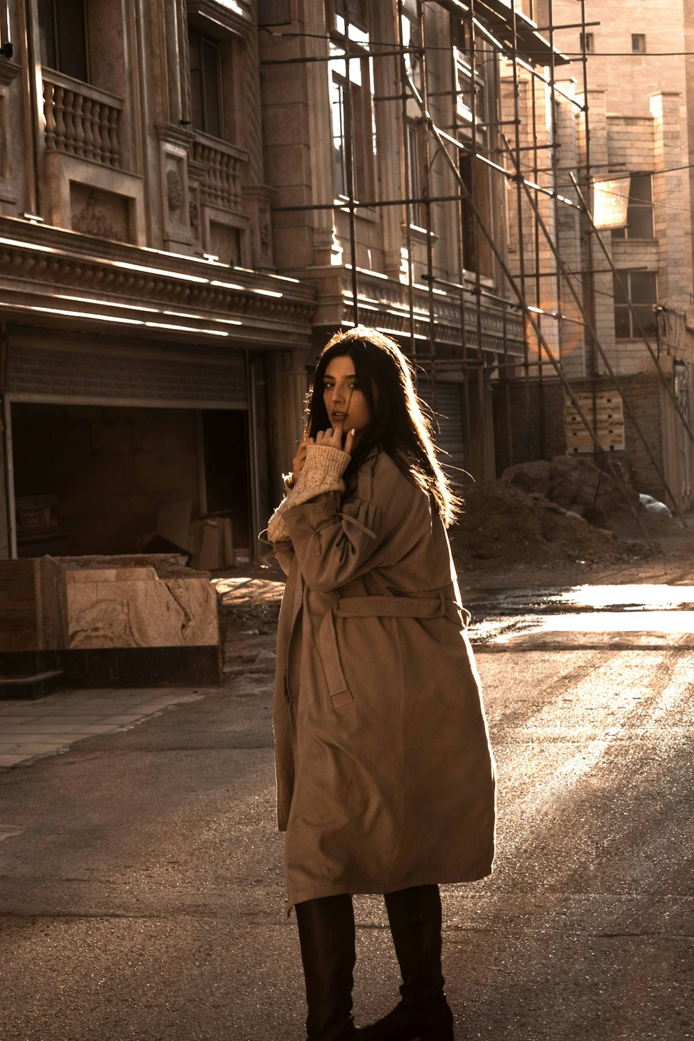 a woman standing in the middle of a street