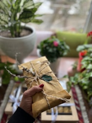 A delivery person handing over a beautifully wrapped package at a doorstep.