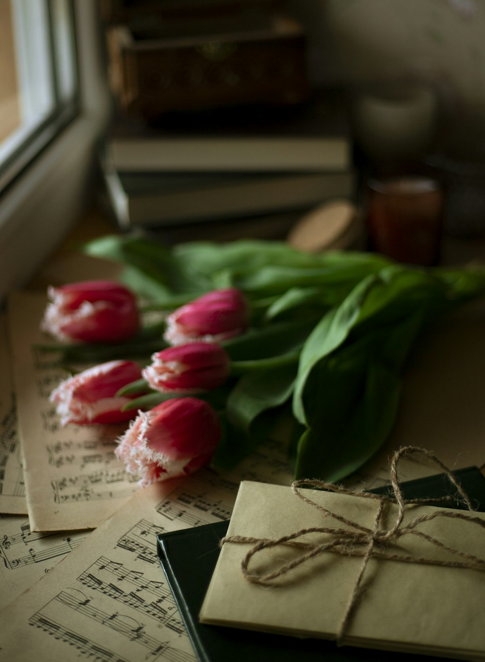 a bunch of pink tulips sitting on top of a table