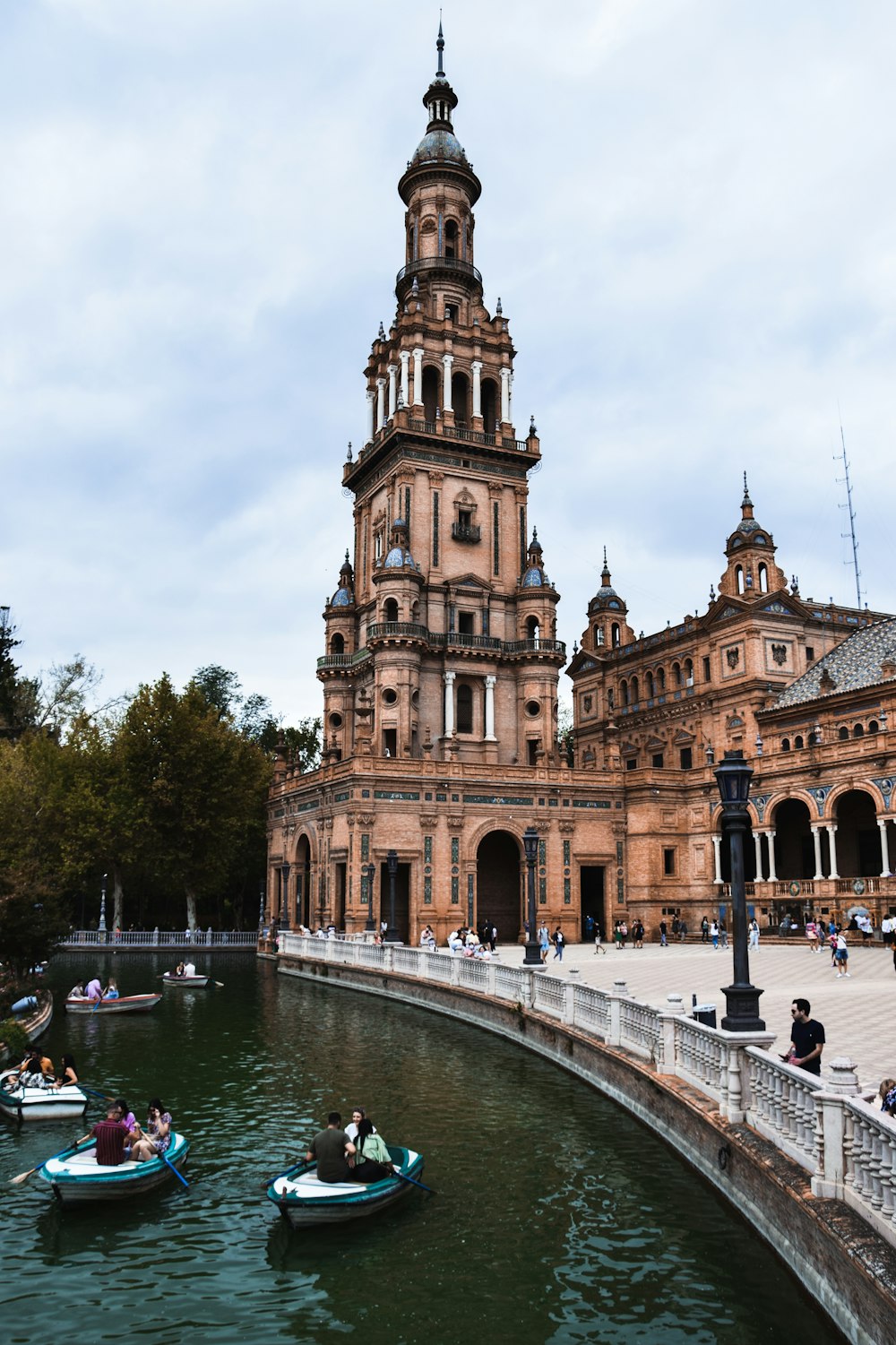 a large building with a tower next to a body of water