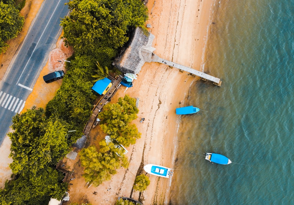 an aerial view of a beach with several boats