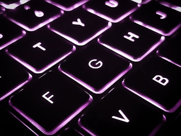 a close up of a keyboard with a purple light