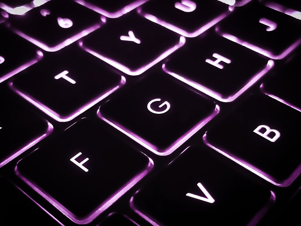 a close up of a keyboard with a purple light