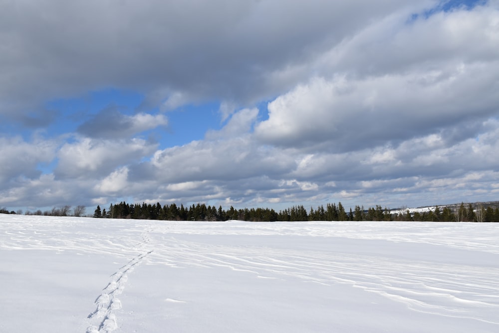 a person walking across a snow covered field