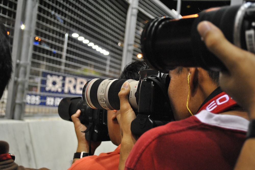 a man holding a camera up to take a picture