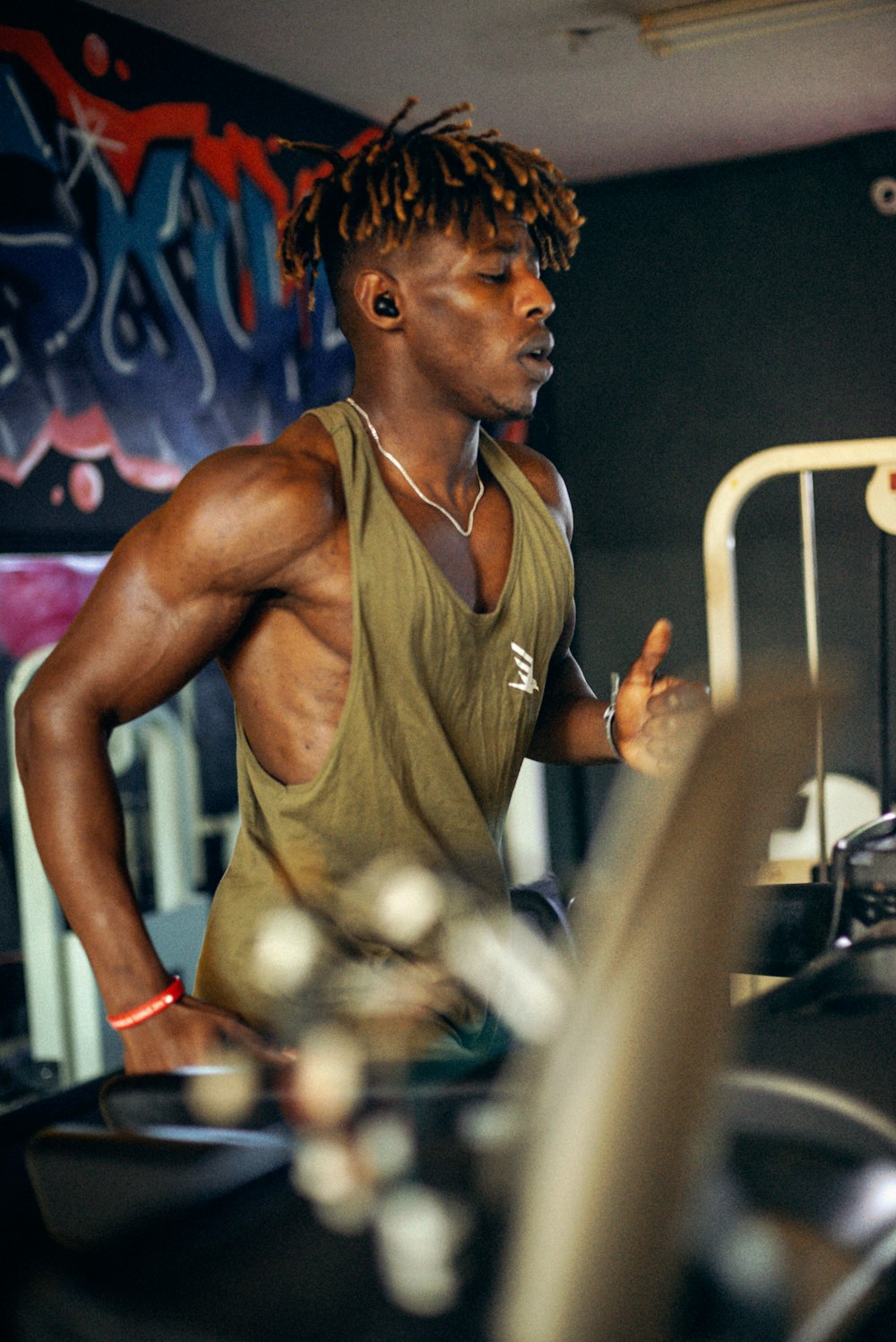 a man standing in front of a gym machine