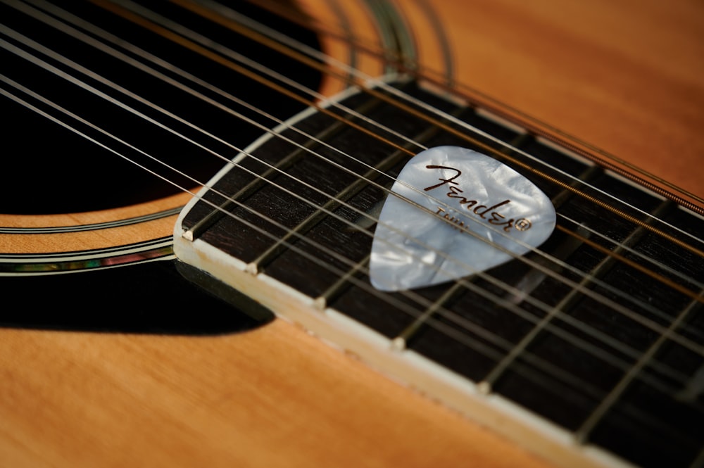 a close up of a guitar pick on a guitar