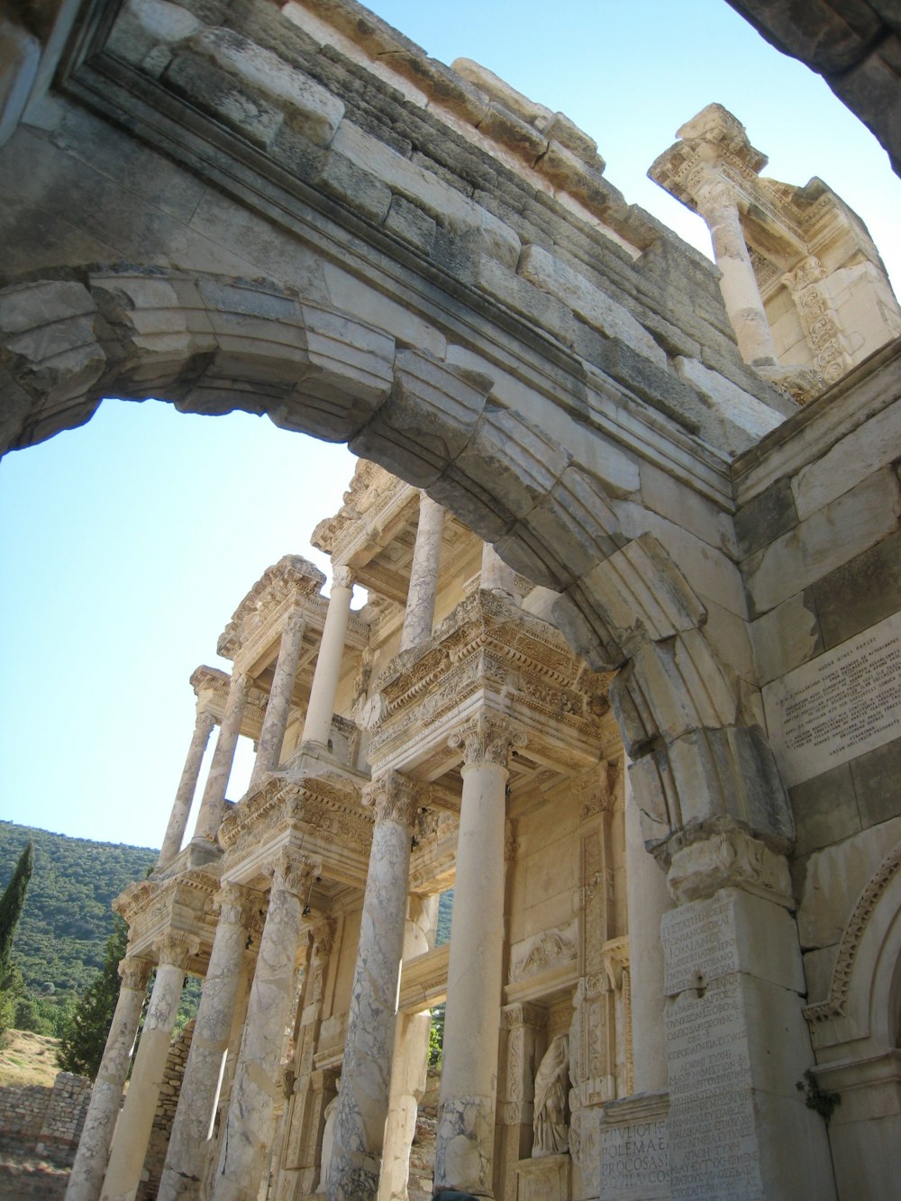 an arch in a stone building with columns