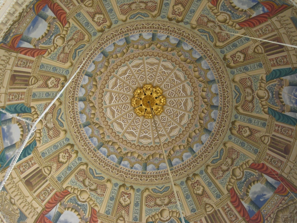 the ceiling of a building with a circular design on it