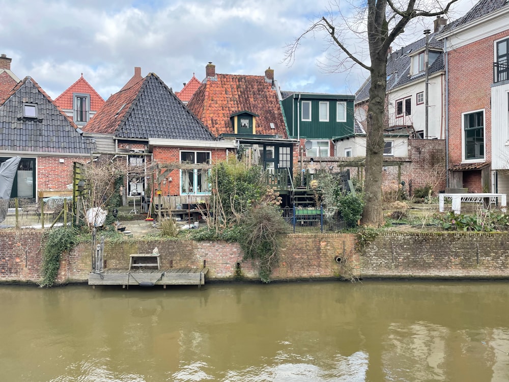 a row of houses next to a body of water