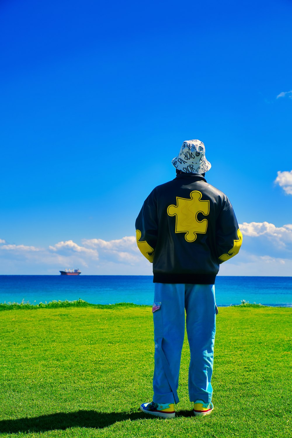 a man standing on top of a lush green field