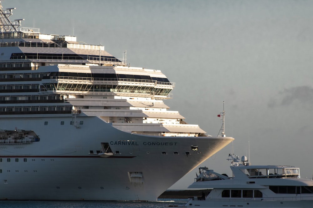 a large cruise ship and a smaller boat in the water