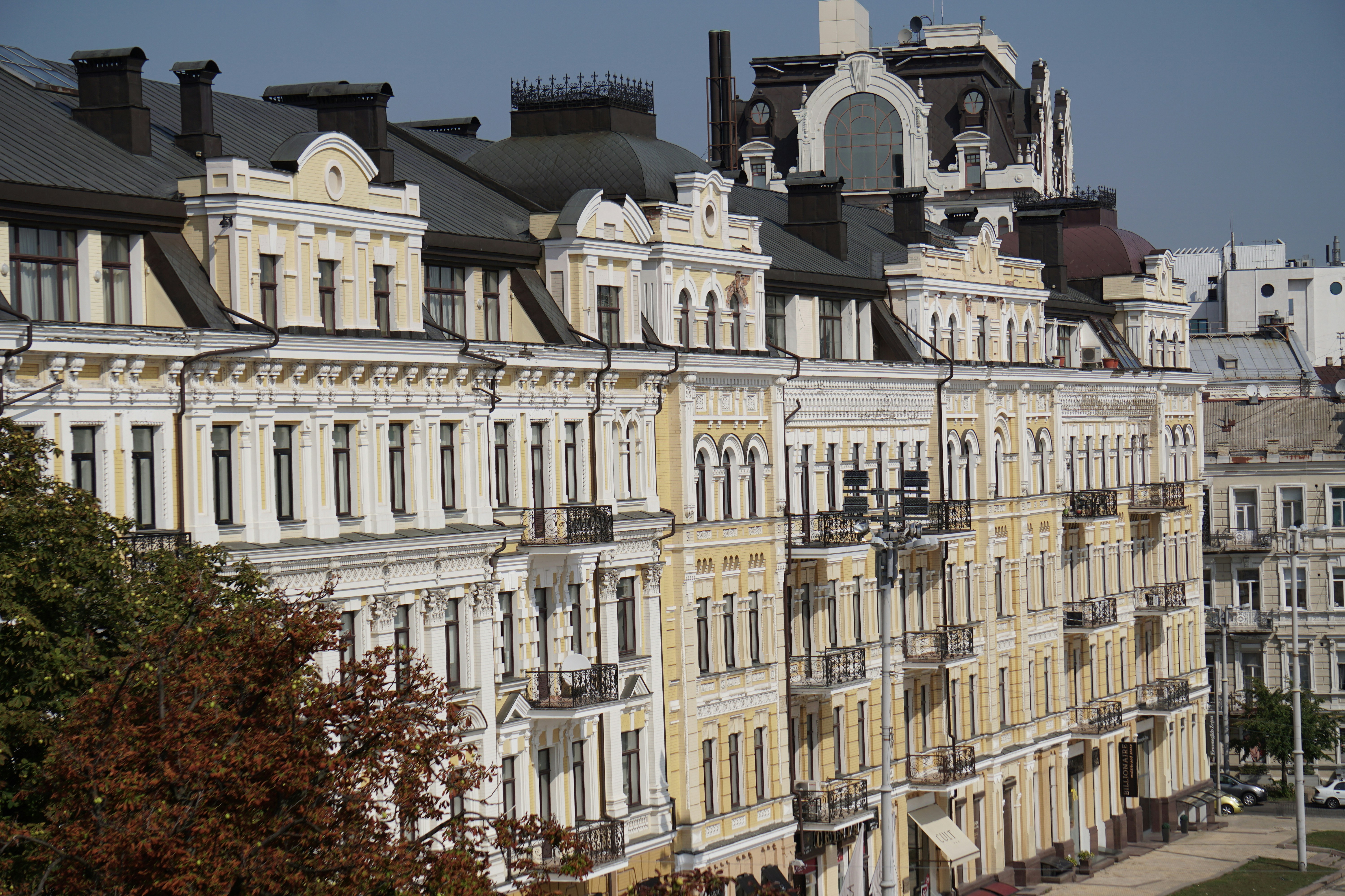a row of buildings with a clock tower in the background