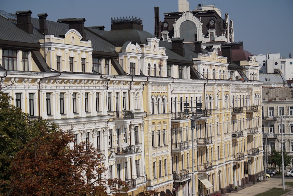 a row of buildings with a clock tower in the background