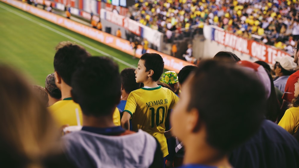 a group of people standing on top of a soccer field