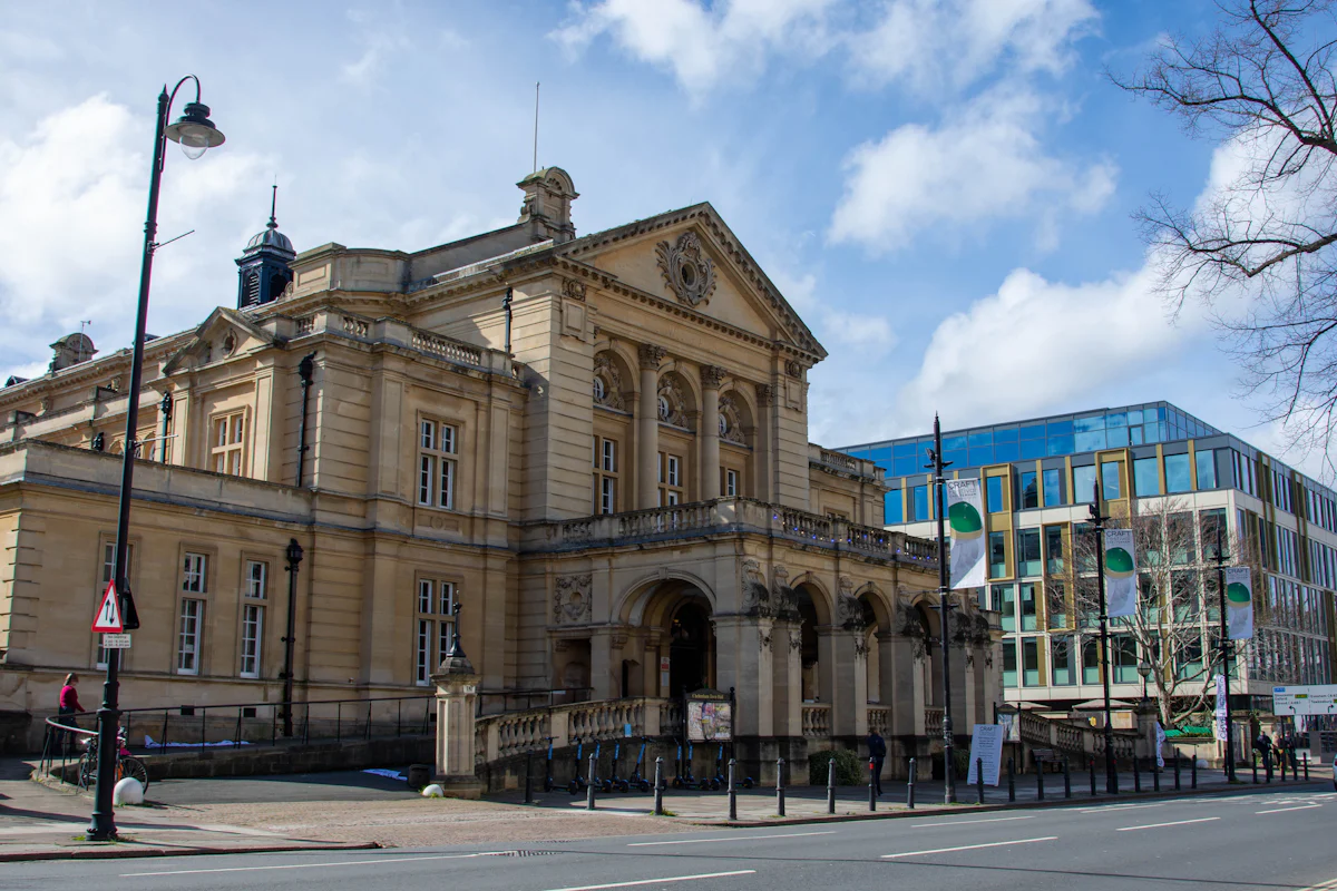A large civic building with a clock tower against the sky