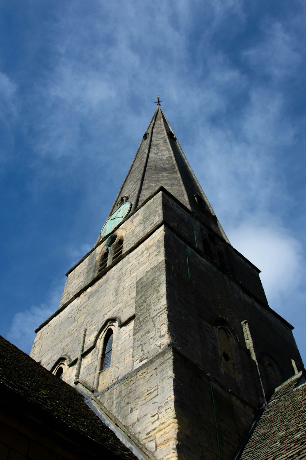 a very tall tower with a clock on it's side