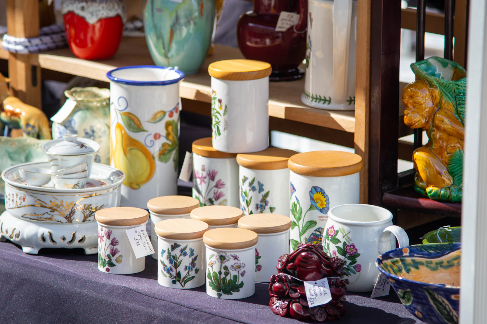 A market table covered in handmade ceramic cups and bowls