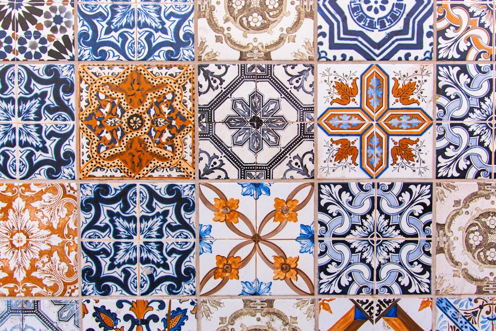 a close up of a tiled wall with different designs