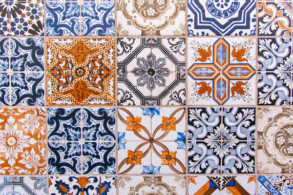 Porcelain vs. Ceramic Tile: a close up of a tiled wall with different designs