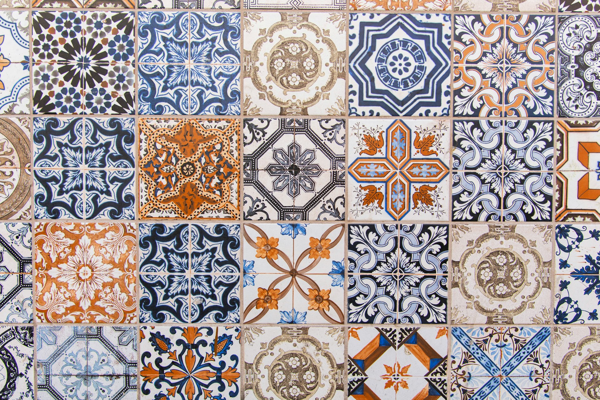 a close up of a tiled wall with different designs