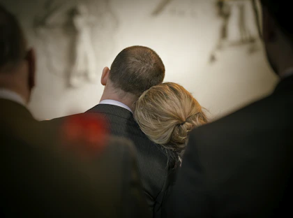 a man and a woman looking at the camera