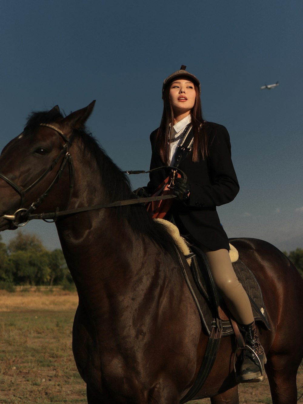 a person riding on the back of a brown horse