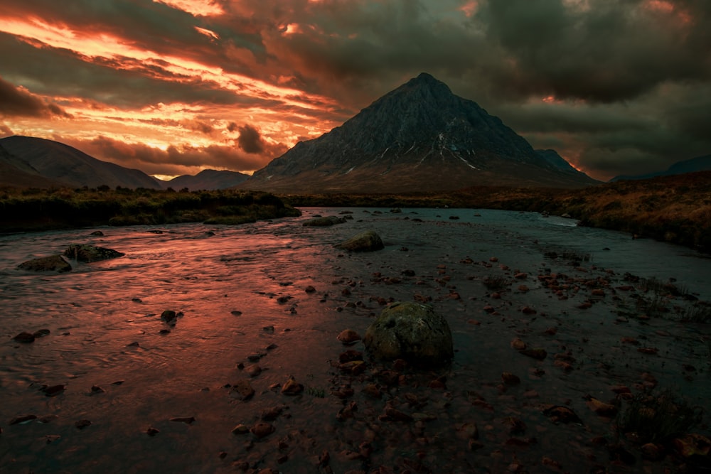 a body of water with a mountain in the background