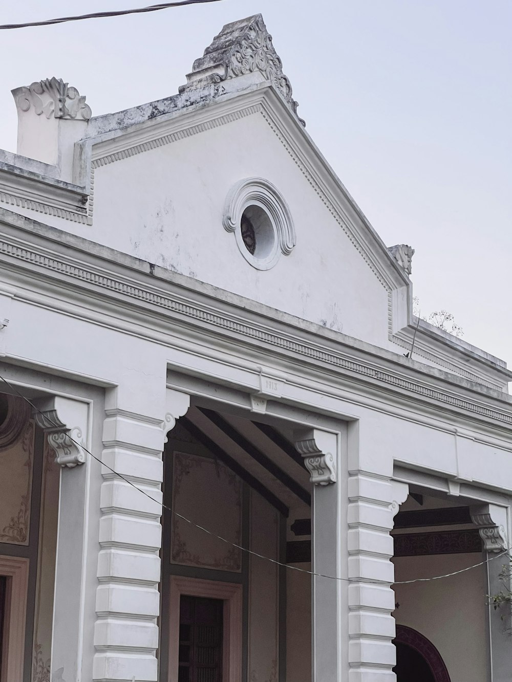 a white building with a clock on the front of it