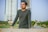 a man leaning on a wall in front of a tall building